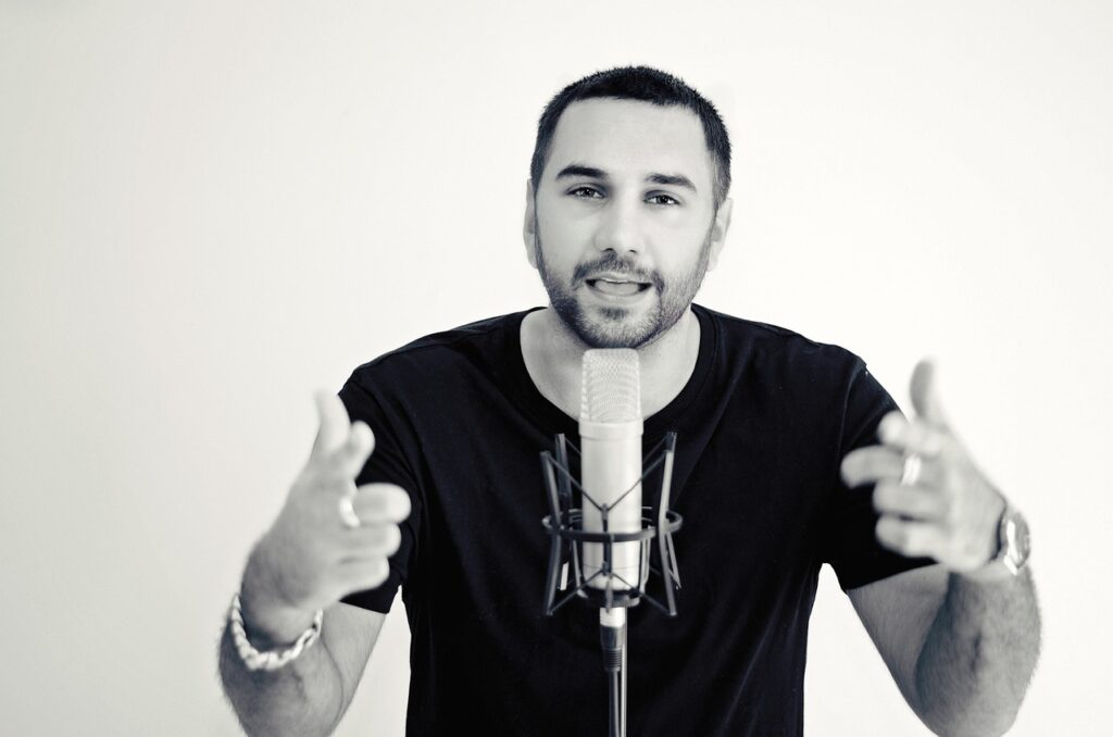 Man speaking at a microphone