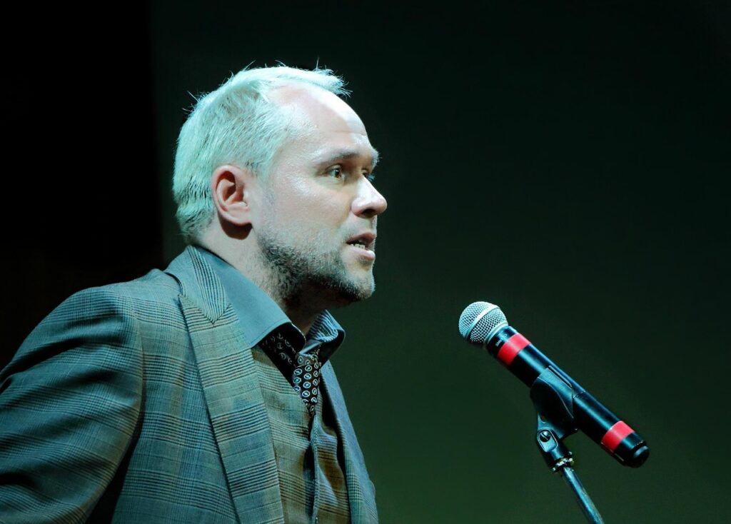 Man at microphone.  Probably giving a speech.